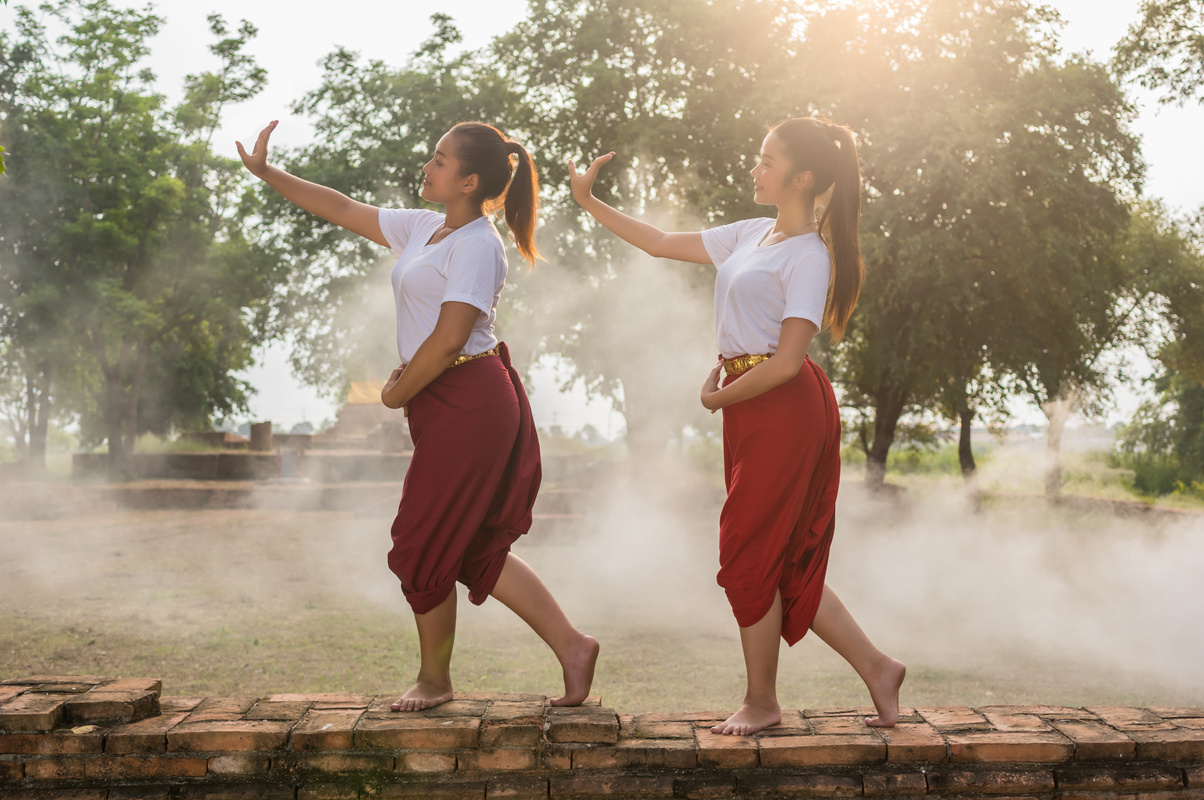 Two Beautiful young girl Thai Dancing art, pantomime performance